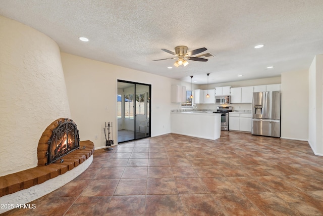 unfurnished living room featuring visible vents, recessed lighting, a textured ceiling, and ceiling fan