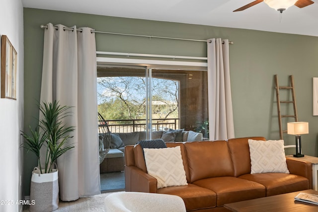 living room with ceiling fan and carpet flooring