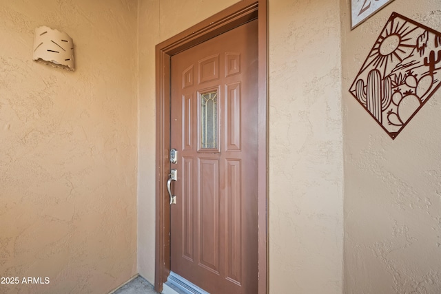 view of exterior entry with stucco siding