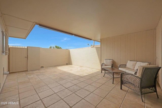 view of patio / terrace featuring an outdoor living space and fence