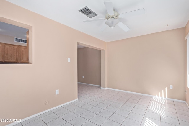 tiled spare room with ceiling fan