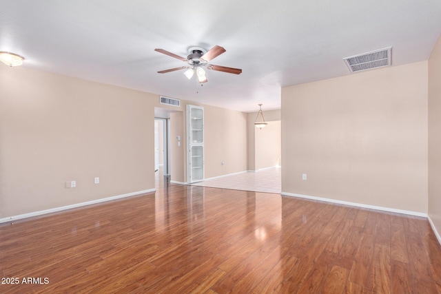 unfurnished room featuring ceiling fan and wood-type flooring