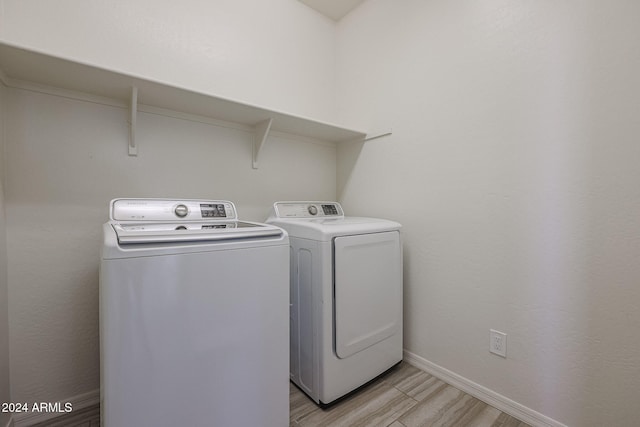 laundry area featuring light hardwood / wood-style floors and independent washer and dryer