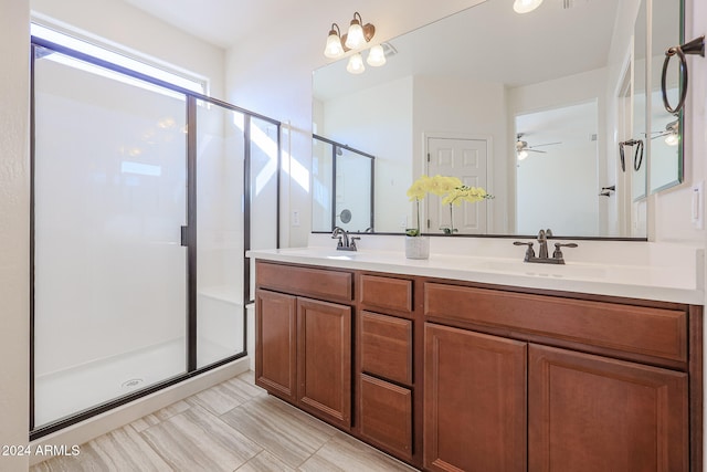 bathroom featuring vanity, ceiling fan, and a shower with shower door