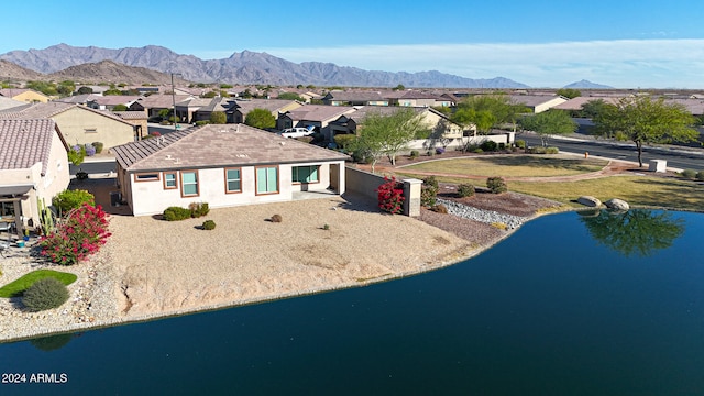 exterior space with a water and mountain view