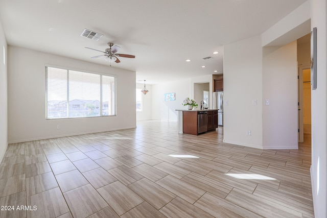 empty room featuring sink and ceiling fan