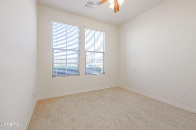 carpeted spare room featuring ceiling fan and lofted ceiling