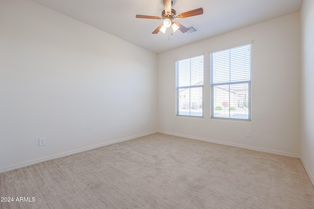 carpeted empty room featuring ceiling fan