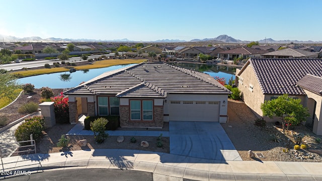 view of front of house featuring a garage and a water and mountain view