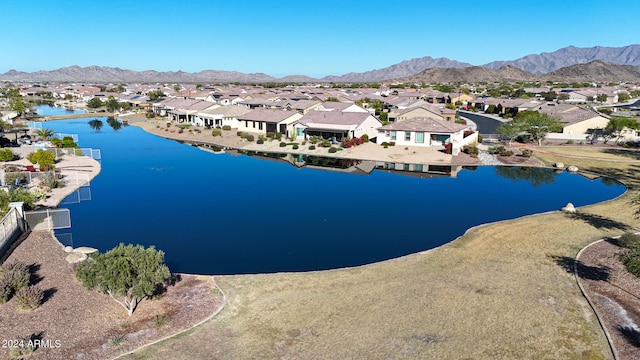 drone / aerial view with a water and mountain view