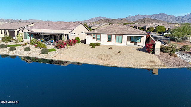 ranch-style house with a water and mountain view