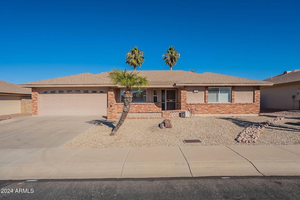 ranch-style house with cooling unit and a garage