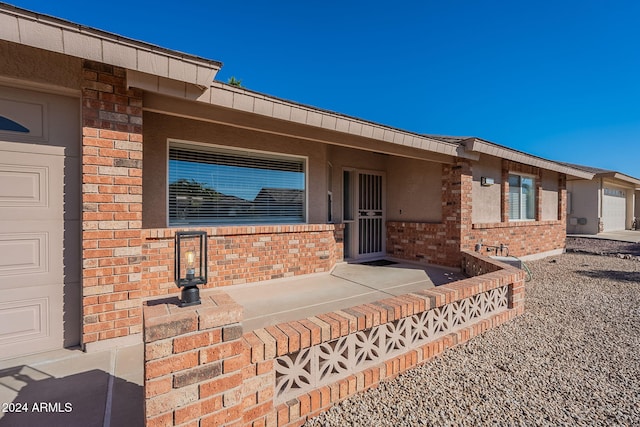 view of exterior entry with a garage