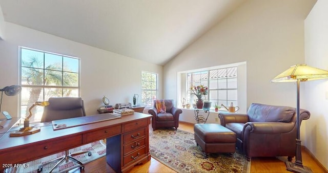 office featuring light wood-type flooring and high vaulted ceiling