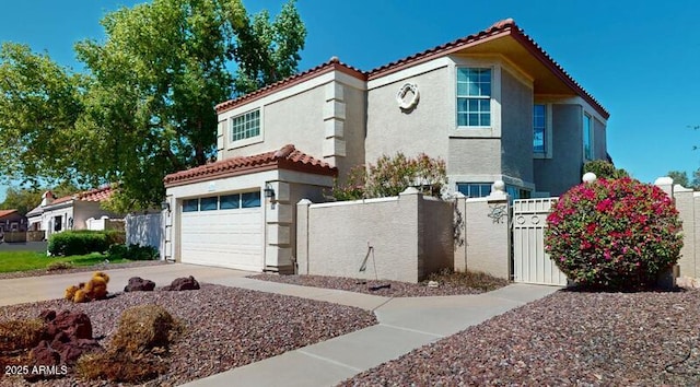 view of front of house featuring stucco siding, a fenced front yard, concrete driveway, an attached garage, and a tiled roof