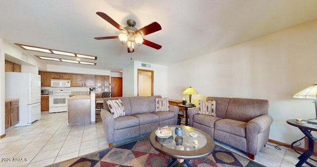 living room featuring light tile patterned floors, a ceiling fan, and visible vents