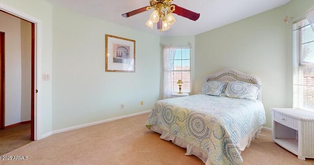 bedroom featuring baseboards, multiple windows, ceiling fan, and carpet flooring