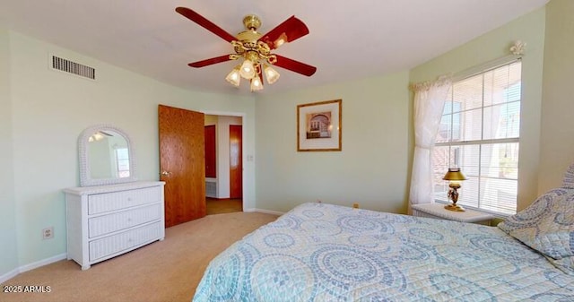 carpeted bedroom featuring visible vents, baseboards, and a ceiling fan