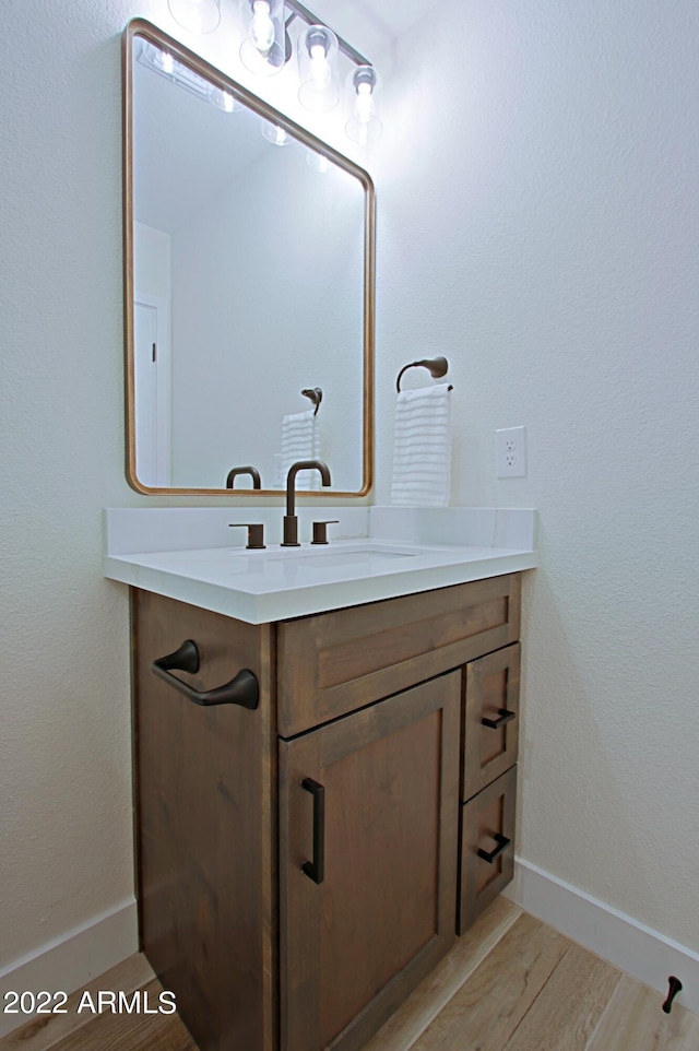 bathroom with vanity and hardwood / wood-style floors