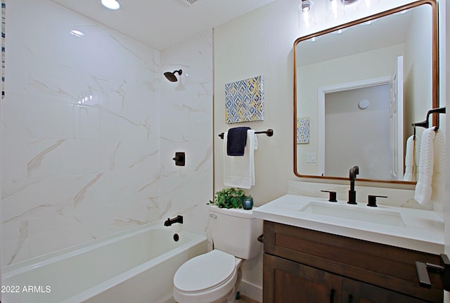 full bathroom with toilet, tiled shower / bath, and vanity