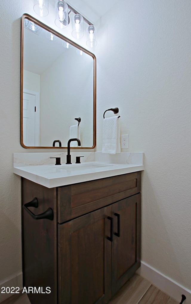 bathroom featuring vanity and hardwood / wood-style flooring