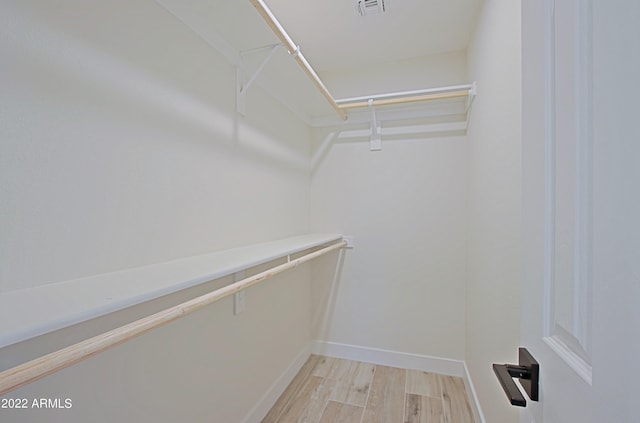 walk in closet featuring light hardwood / wood-style floors