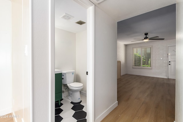 hall with hardwood / wood-style floors and tile walls