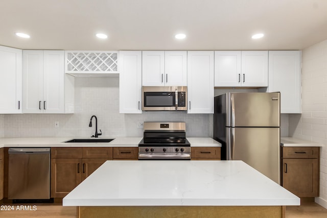 kitchen with sink, white cabinets, and appliances with stainless steel finishes