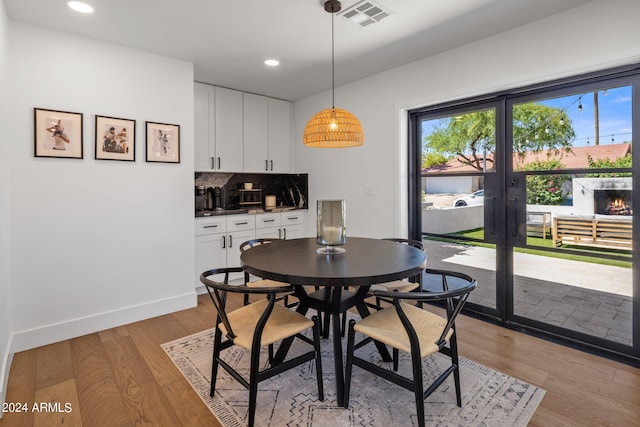 dining space featuring light hardwood / wood-style flooring and french doors