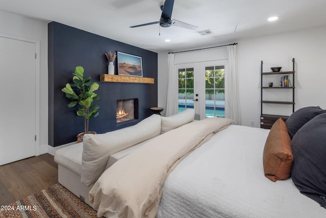 bedroom featuring access to outside, french doors, dark hardwood / wood-style floors, and ceiling fan