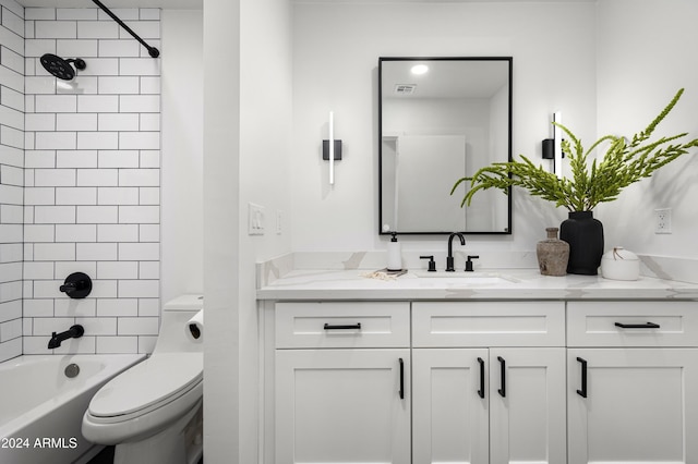 full bathroom featuring vanity, toilet, and tiled shower / bath