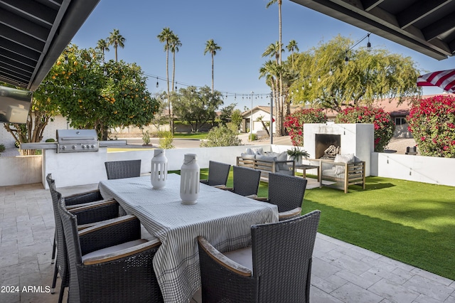 view of patio featuring an outdoor living space with a fireplace, a grill, and an outdoor kitchen