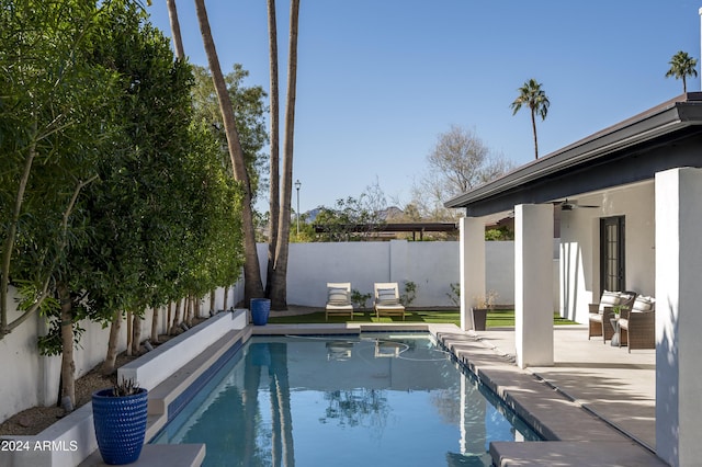 view of pool with ceiling fan and a patio area