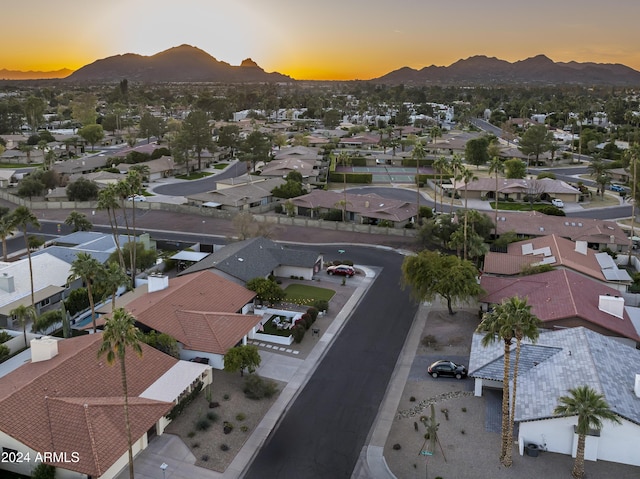 aerial view at dusk featuring a mountain view