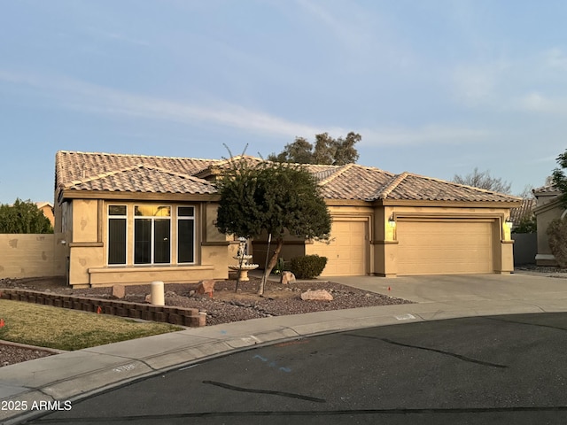 view of front of house with a tile roof, driveway, and stucco siding