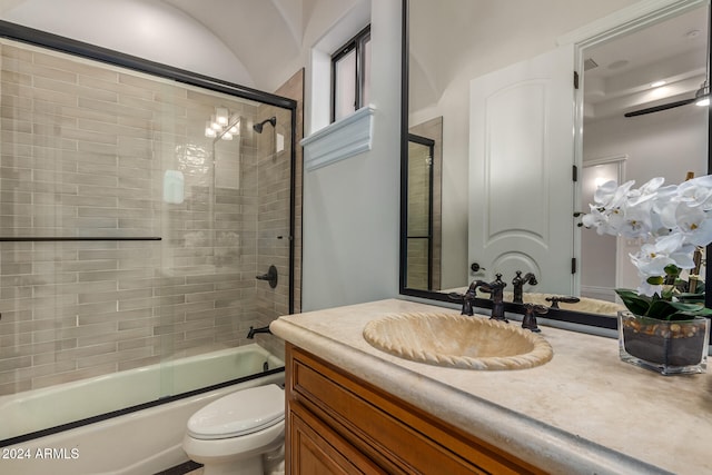 full bathroom featuring shower / bath combination with glass door, vanity, and toilet