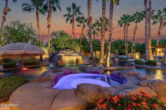 view of pool at dusk