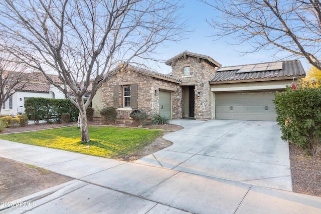 view of front of home featuring a garage, a front lawn, and solar panels