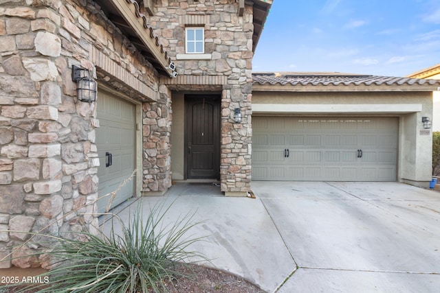 view of exterior entry with a garage