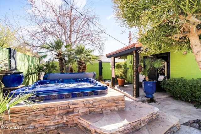 view of patio / terrace with a covered hot tub