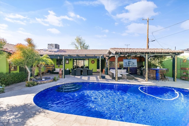 view of swimming pool with exterior bar, an outdoor hangout area, a patio area, and central air condition unit