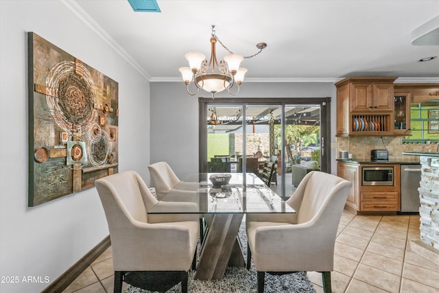 dining area featuring light tile patterned floors, ornamental molding, and a chandelier