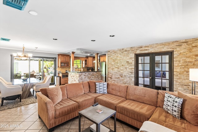 living room featuring french doors, ornamental molding, light tile patterned flooring, and a notable chandelier