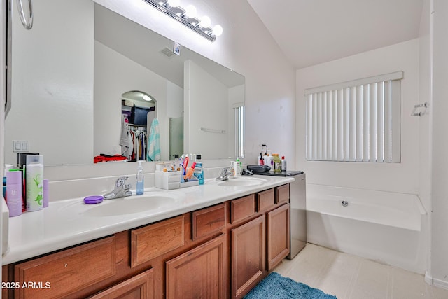 4318 W Apollo Rd, Laveen, AZ 85339 - full bathroom with vaulted ceiling, double vanity, a bath, and a spacious closet