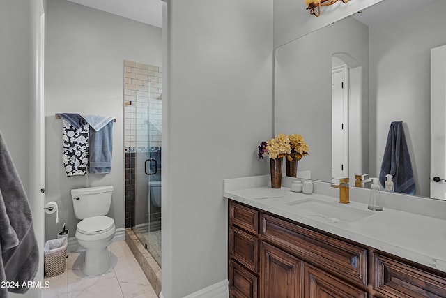 bathroom featuring vanity, toilet, and a shower with door