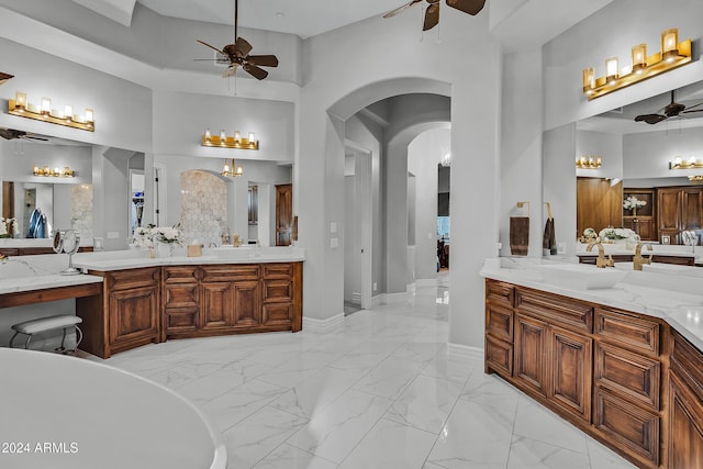 bathroom featuring a tub to relax in, vanity, and a high ceiling