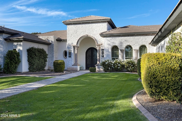 view of front of property with french doors and a front yard