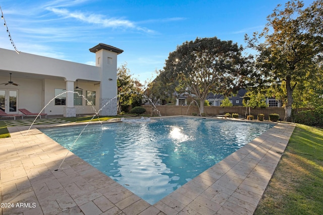 view of pool with pool water feature and a patio