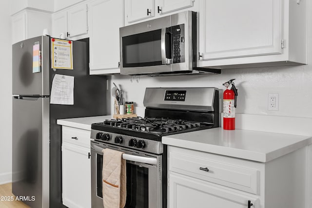 1111 E Turney Ave Unit 3, Phoenix, AZ 85014 - kitchen featuring appliances with stainless steel finishes, light countertops, and white cabinetry