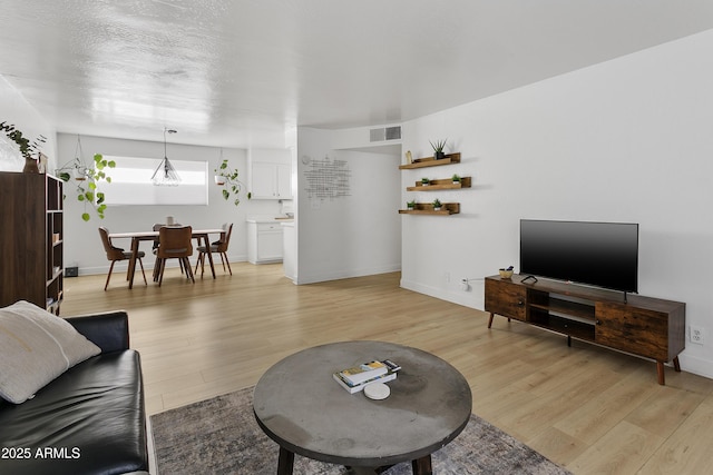1111 E Turney Ave Unit 3, Phoenix, AZ 85014 - living area featuring light wood-style floors and baseboards
